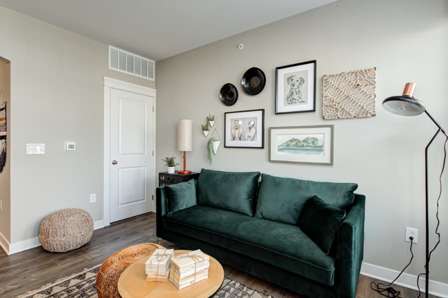 Apartment living area with sofa, wall art, and lighting